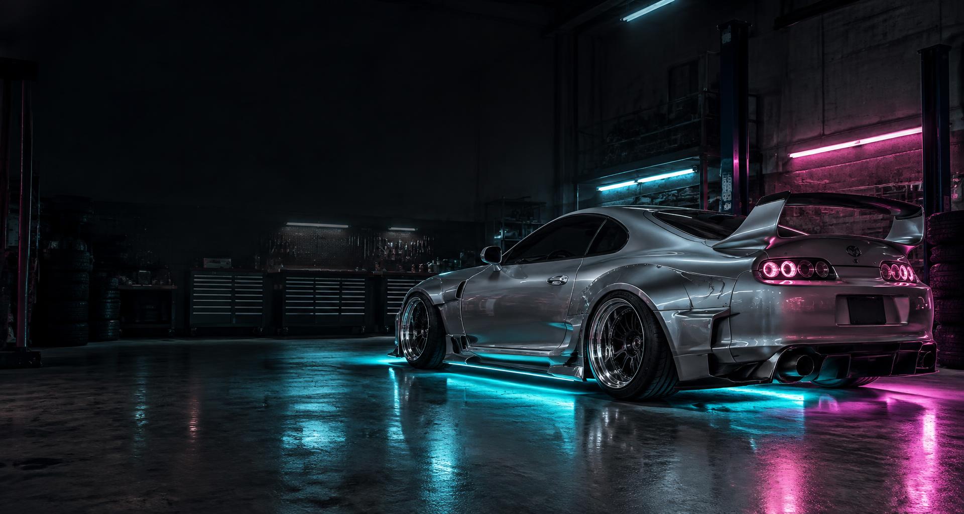 Silver tuner car with cyan underglow and pink taillights in a neon-lit garage